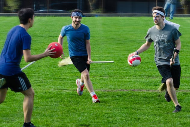 three people playing Qudditch